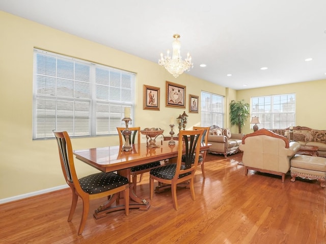 dining room featuring light hardwood / wood-style floors and a notable chandelier