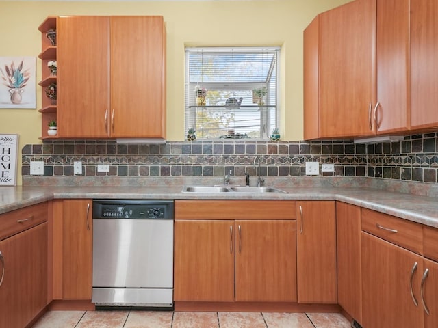 kitchen featuring backsplash, dishwasher, light tile patterned flooring, and sink