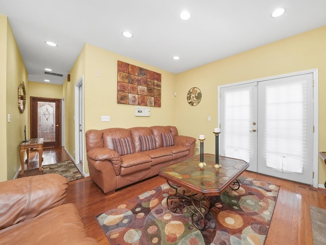 living room with hardwood / wood-style floors and french doors