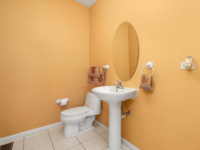 bathroom with tile patterned flooring and toilet