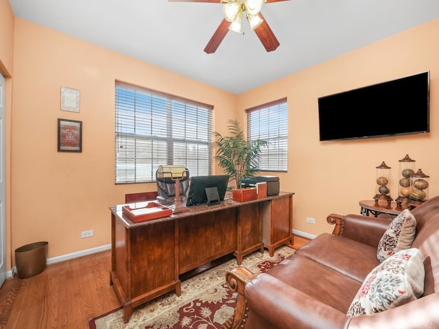 home office featuring ceiling fan and light hardwood / wood-style flooring