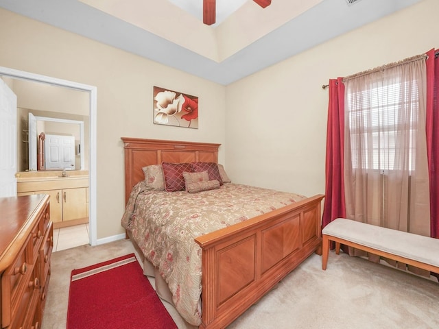 carpeted bedroom featuring ceiling fan and ensuite bathroom