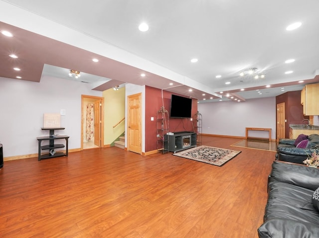 living room featuring hardwood / wood-style flooring and sink