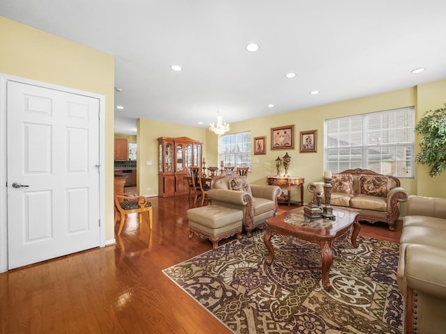 living room with hardwood / wood-style flooring, a chandelier, and a wealth of natural light