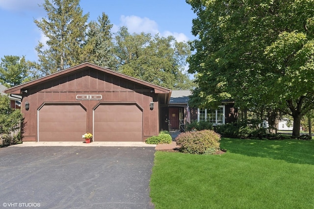 33 E Maple Ave, Cortland, IL 60112 - view of front of home with a garage, a front yard, and asphalt driveway