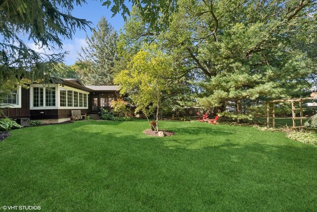 33 E Maple Ave, Cortland, IL 60112 - view of grassy yard featuring a sunroom