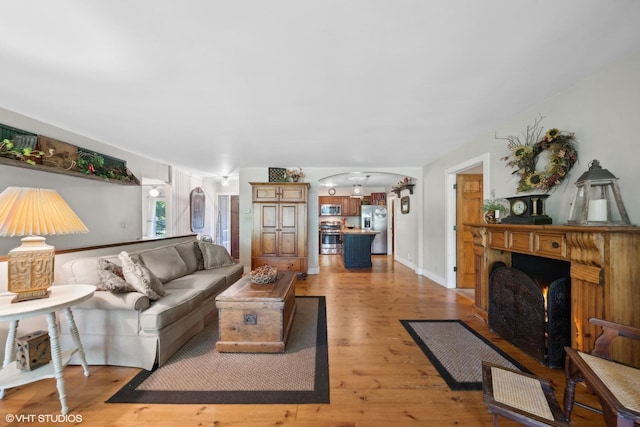 33 E Maple Ave, Cortland, IL 60112 - living room with arched walkways and light wood-type flooring