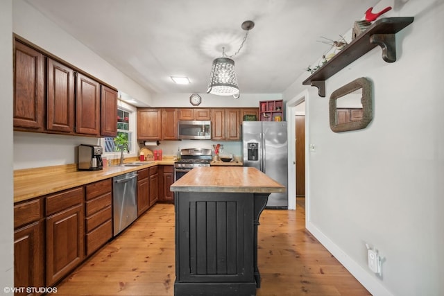 33 E Maple Ave, Cortland, IL 60112 - kitchen featuring stainless steel appliances, light wood-type flooring, a sink, a kitchen island, and open shelves