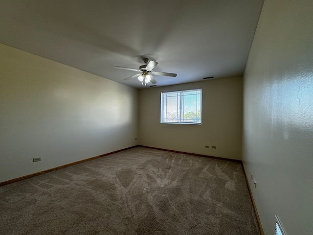 carpeted empty room featuring ceiling fan