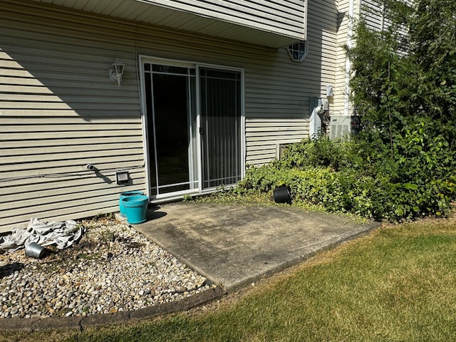 doorway to property featuring a lawn and a patio