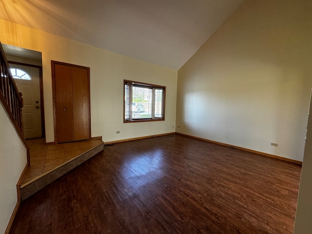 unfurnished room with high vaulted ceiling and hardwood / wood-style floors