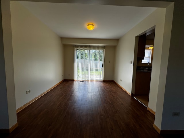 unfurnished room with dark hardwood / wood-style flooring