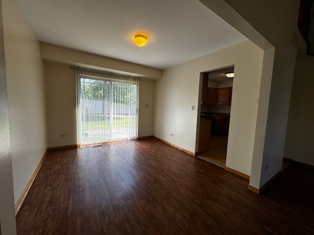 unfurnished room with dark hardwood / wood-style floors