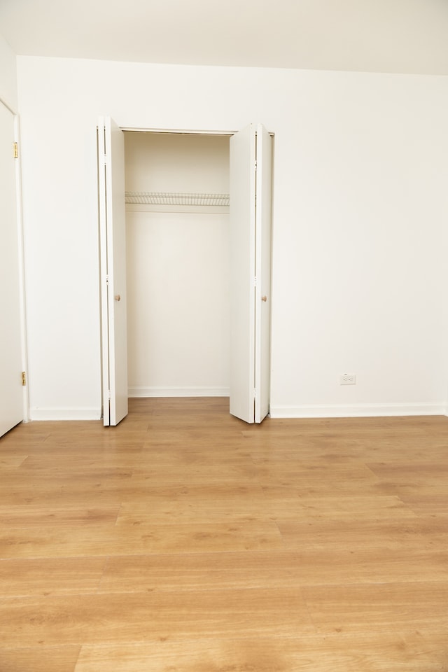 unfurnished bedroom with light wood-type flooring