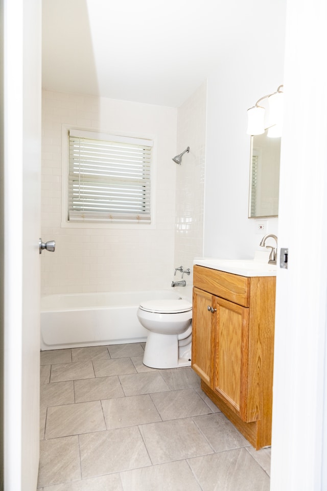 full bathroom featuring vanity, toilet, tile patterned flooring, and tiled shower / bath