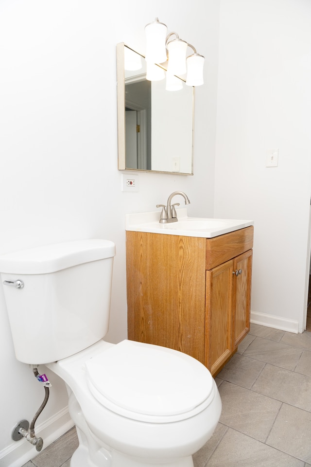 bathroom with vanity, toilet, and tile patterned flooring