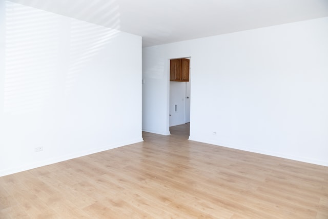 unfurnished room with light hardwood / wood-style flooring