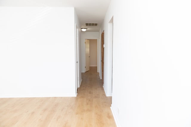 corridor with light wood-type flooring