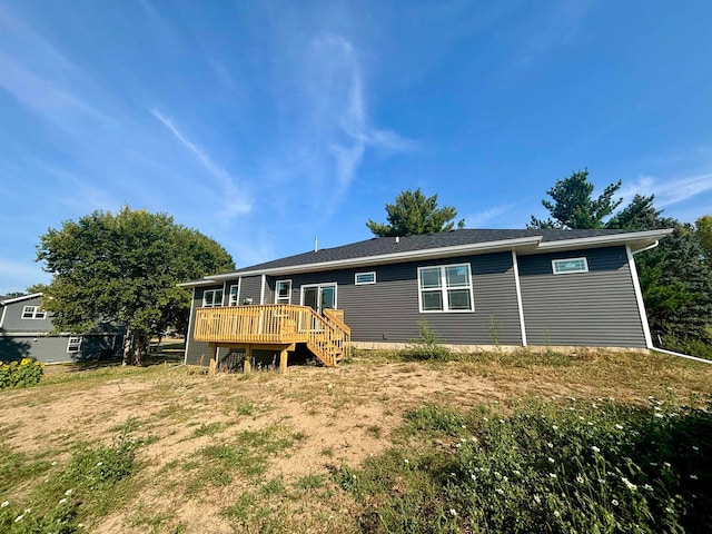 rear view of property with a yard and a wooden deck