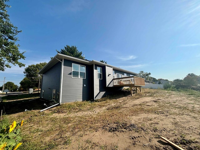 back of house featuring a wooden deck