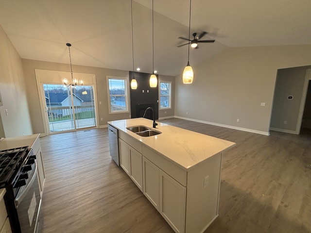 kitchen with lofted ceiling, sink, dark hardwood / wood-style floors, an island with sink, and stainless steel appliances