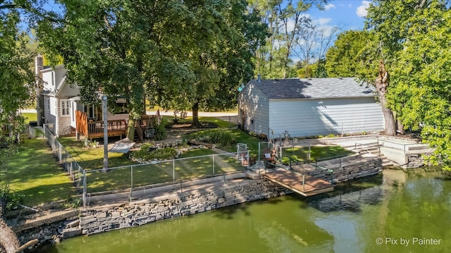 dock area featuring a lawn and a deck with water view