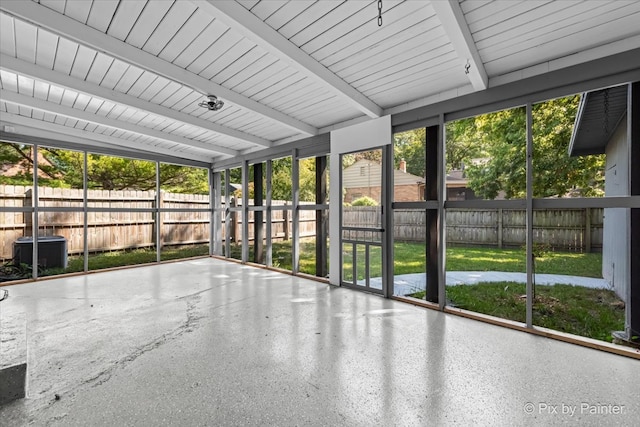 unfurnished sunroom featuring beamed ceiling