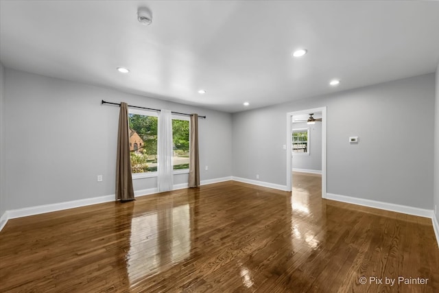 spare room featuring ceiling fan and dark wood-type flooring