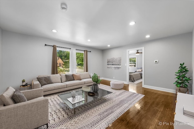 living room featuring ceiling fan and hardwood / wood-style floors