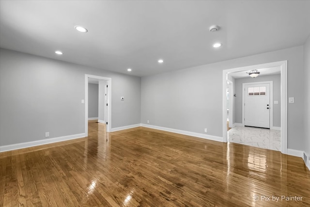 spare room with wood-type flooring