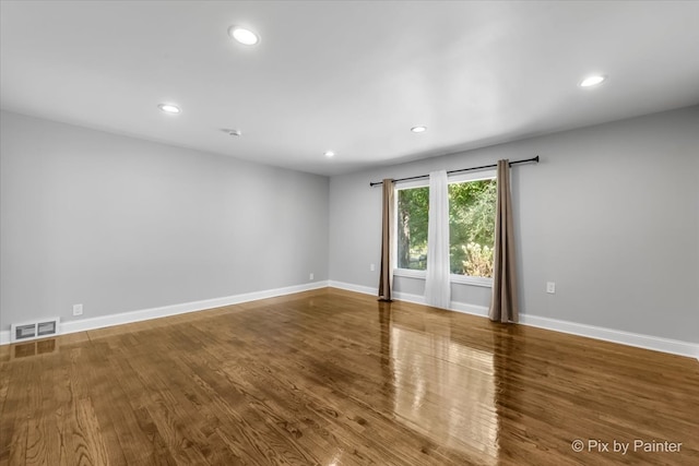 unfurnished room with wood-type flooring