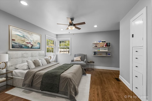 bedroom with ceiling fan and dark hardwood / wood-style flooring