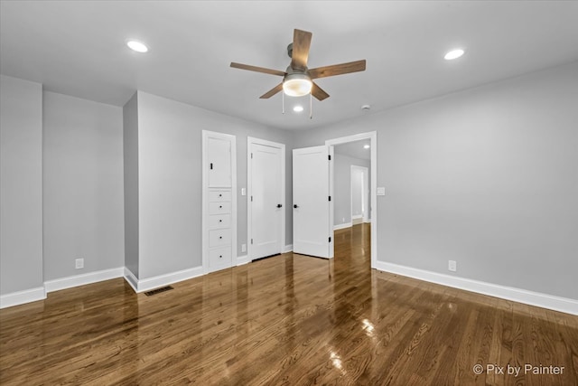 unfurnished bedroom with ceiling fan and hardwood / wood-style floors