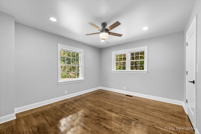 unfurnished room with ceiling fan and dark wood-type flooring