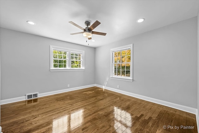 spare room with ceiling fan and dark hardwood / wood-style floors