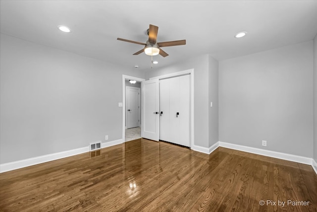 unfurnished bedroom with a closet, ceiling fan, and hardwood / wood-style floors