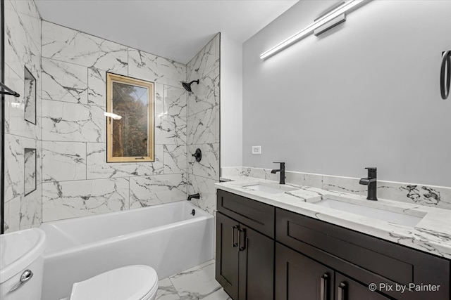 full bathroom with vanity, tiled shower / bath, and toilet