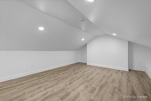 bonus room featuring lofted ceiling and light wood-type flooring