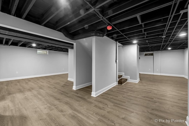 basement with hardwood / wood-style floors