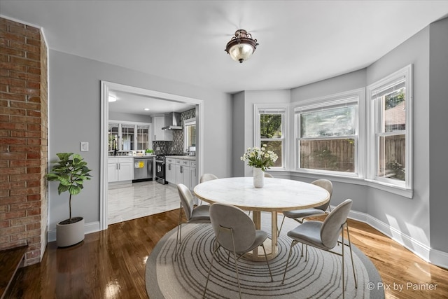 dining space with hardwood / wood-style flooring