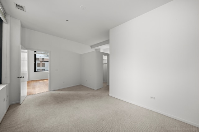 unfurnished room featuring light carpet