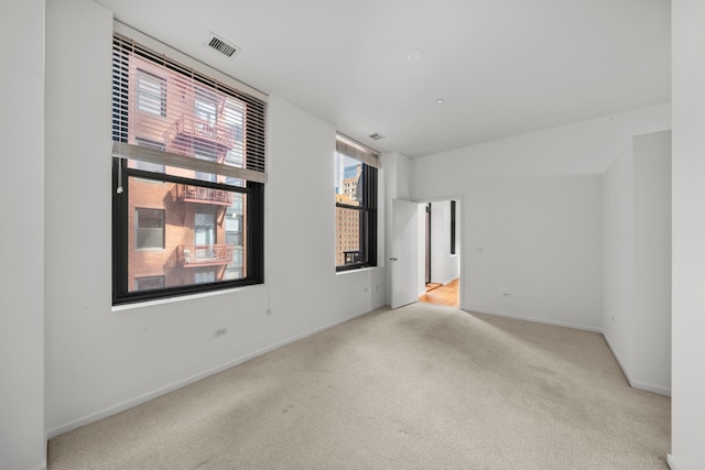 spare room featuring light colored carpet