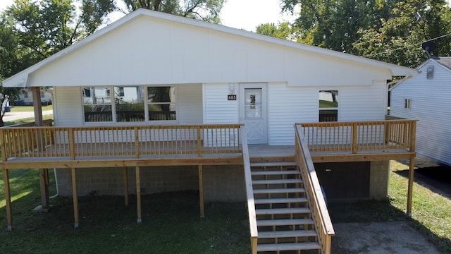 back of property with a wooden deck