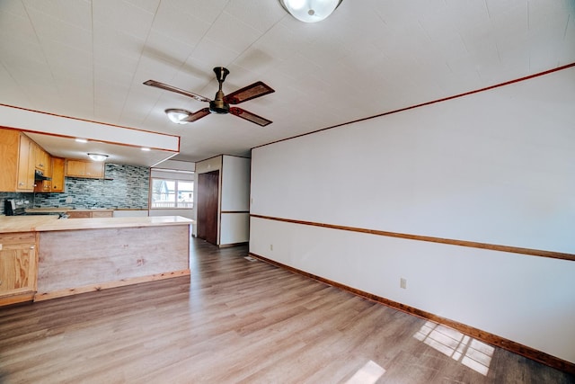 465 E Ash St, Watseka, IL 60970 - kitchen featuring electric stove, light countertops, light wood finished floors, a ceiling fan, and a peninsula