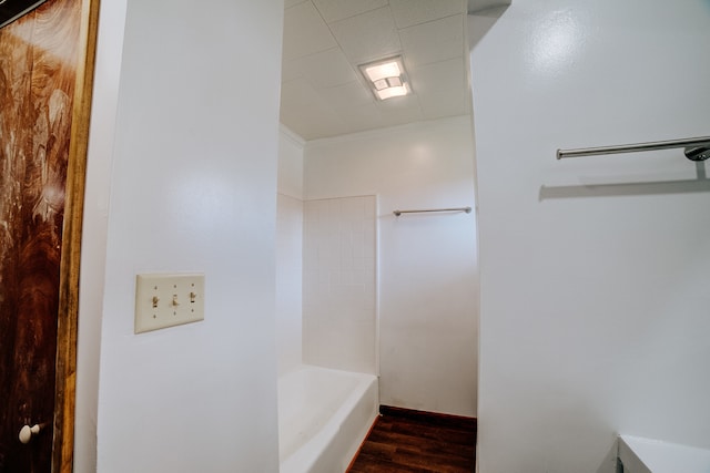 bathroom featuring shower / bathtub combination and hardwood / wood-style flooring