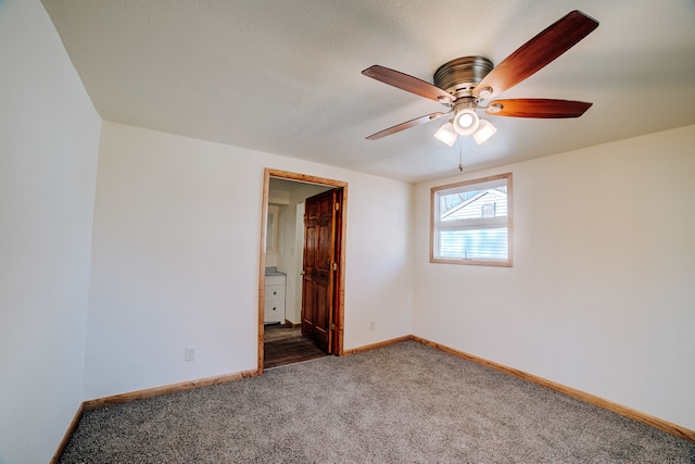 unfurnished room featuring dark colored carpet and ceiling fan