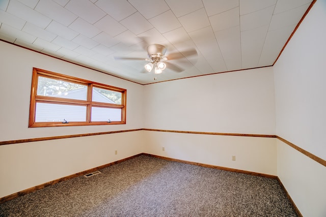 empty room featuring carpet flooring, ornamental molding, and ceiling fan