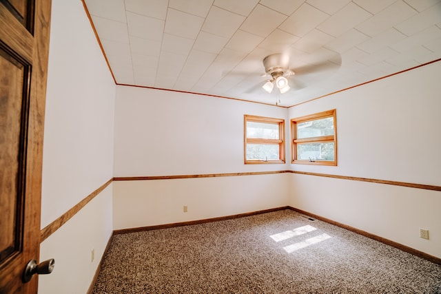 carpeted spare room with ornamental molding and ceiling fan