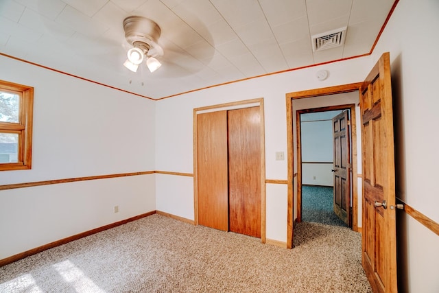 465 E Ash St, Watseka, IL 60970 - unfurnished bedroom with carpet floors, a closet, baseboards, and a ceiling fan