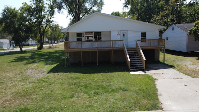 back of property featuring a wooden deck and a yard